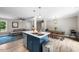 Eat-in kitchen features an island with a sink, stainless steel appliances, and flows into the living space at 5020 Mimosa Dr, Durham, NC 27713