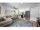 Inviting living area with new floors, light colors, a comfortable sofa, and seamlessly connects to the kitchen at 5020 Mimosa Dr, Durham, NC 27713