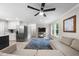 Open living space with new floors, gray sofa, ceiling fan, and a large window providing natural light at 5020 Mimosa Dr, Durham, NC 27713