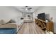 Cozy living room featuring a large sectional sofa, TV, and wood-look floors at 5020 Mimosa Dr, Durham, NC 27713