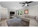 Living room boasting wood-look floors, a stylish rug, a comfortable couch, and natural light from the window at 5020 Mimosa Dr, Durham, NC 27713