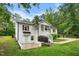 Exterior shot of the home showcasing brick, a cozy porch, manicured shrubs, and a well-maintained lawn at 5020 Mimosa Dr, Durham, NC 27713