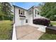 Side exterior view of brick home with a manicured lawn, porch, and a driveway at 5020 Mimosa Dr, Durham, NC 27713