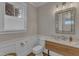 Charming powder room featuring a wooden vanity and stylish fixtures at 511 Hamilton Cottage Way, Raleigh, NC 27605