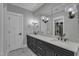 A dual sink vanity with granite countertops and a large mirror in this bathroom at 511 Hamilton Cottage Way, Raleigh, NC 27605