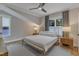 This bedroom features neutral tones, a ceiling fan, and a large window allowing plenty of natural light at 511 Hamilton Cottage Way, Raleigh, NC 27605
