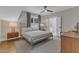 This bedroom features stylish furnishings, a ceiling fan, and an ensuite bathroom with double doors at 511 Hamilton Cottage Way, Raleigh, NC 27605