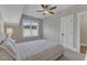 This bedroom features neutral tones, a ceiling fan, and a large window allowing plenty of natural light at 511 Hamilton Cottage Way, Raleigh, NC 27605