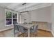 Bright dining room featuring a modern chandelier and ample natural light at 511 Hamilton Cottage Way, Raleigh, NC 27605