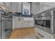 Bright kitchen featuring stainless steel appliances, a farmhouse sink, and white countertops at 511 Hamilton Cottage Way, Raleigh, NC 27605