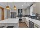 Stunning kitchen featuring an island, stainless appliances, and stylish pendant lighting at 511 Hamilton Cottage Way, Raleigh, NC 27605