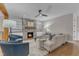 Comfortable living room with a stone fireplace, built-in shelving, and hardwood floors at 511 Hamilton Cottage Way, Raleigh, NC 27605