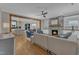 Open-concept living room with a stone fireplace, built-in shelving, and hardwood floors at 511 Hamilton Cottage Way, Raleigh, NC 27605