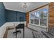 Bright office with a large window, wood-paneled accent wall, and modern lighting at 511 Hamilton Cottage Way, Raleigh, NC 27605