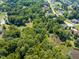 Expansive wooded lot offers privacy, with glimpses of neighborhood homes and a charming red shed at 5308 Stableview Ct, Holly Springs, NC 27540