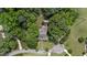 Aerial view of the home with a long driveway and mature landscaping surrounding the property at 5308 Stableview Ct, Holly Springs, NC 27540