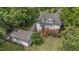 Aerial view of home, backyard with deck and landscaping; showcasing surrounding greenery at 5308 Stableview Ct, Holly Springs, NC 27540