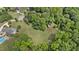 Expansive property with a charming red barn, surrounded by lush trees and greenery at 5308 Stableview Ct, Holly Springs, NC 27540