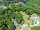 Beautiful aerial perspective of several residences, a pond, and meticulously landscaped grounds at 5308 Stableview Ct, Holly Springs, NC 27540