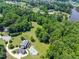 Beautiful estate on expansive lot featuring a pool, patio, and lush greenery at 5308 Stableview Ct, Holly Springs, NC 27540