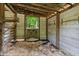 Interior view of the barn features wood construction and a bedding of wood shavings at 5308 Stableview Ct, Holly Springs, NC 27540