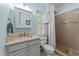 Light blue bathroom with cream vanity and tiled walk-in shower offering a serene and classic design at 5308 Stableview Ct, Holly Springs, NC 27540