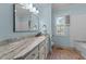 Stylish blue bathroom featuring modern fixtures, a long vanity, and a tub with subway tile at 5308 Stableview Ct, Holly Springs, NC 27540