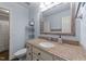 This bathroom features a granite countertop, white cabinets and blue painted walls at 5308 Stableview Ct, Holly Springs, NC 27540