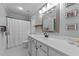 Light and airy bathroom with an ornate mirror, a long vanity, and a classic shower with a curtain at 5308 Stableview Ct, Holly Springs, NC 27540