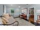 Light-filled bedroom featuring a cozy daybed, desk, and view to the ensuite bathroom at 5308 Stableview Ct, Holly Springs, NC 27540