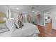 Bright bedroom with hardwood flooring and a glimpse of a cozy sitting area through the open doorway at 5308 Stableview Ct, Holly Springs, NC 27540