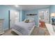 Cozy blue bedroom with an ensuite bathroom and view of a finished attic space at 5308 Stableview Ct, Holly Springs, NC 27540