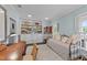 Bedroom featuring a daybed, desk, built-in bookcase, and a view to the ensuite bathroom at 5308 Stableview Ct, Holly Springs, NC 27540