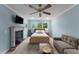 Comfortable bedroom featuring a fireplace, soft lighting, and a relaxing seating area at 5308 Stableview Ct, Holly Springs, NC 27540