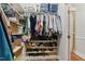 Walk-in closet featuring built-in shelves, shoe racks, and ample storage space at 5308 Stableview Ct, Holly Springs, NC 27540