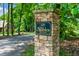 Elegant stone sign marking the entrance to The Stables private community, with lush green trees around at 5308 Stableview Ct, Holly Springs, NC 27540