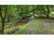 The creek trickles gently beneath a metal bridge in this secluded, wooded area at 5308 Stableview Ct, Holly Springs, NC 27540