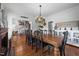 Elegant dining room showcasing a large wooden table, vintage accents, and access to other living spaces at 5308 Stableview Ct, Holly Springs, NC 27540