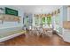 Sunny dining area with large windows, a hanging light fixture, and access to the kitchen at 5308 Stableview Ct, Holly Springs, NC 27540