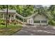 View of a lovely two-car garage with connecting arbor way to the home's entrance at 5308 Stableview Ct, Holly Springs, NC 27540