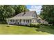 Charming home with a large, inviting porch and manicured lawn, perfect for relaxing and enjoying the outdoors at 5308 Stableview Ct, Holly Springs, NC 27540