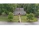 Gorgeous home with a welcoming front porch and a brick walkway, surrounded by lush trees at 5308 Stableview Ct, Holly Springs, NC 27540
