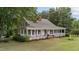 Attractive home featuring a classic wrap-around porch, perfect for enjoying the outdoors at 5308 Stableview Ct, Holly Springs, NC 27540
