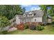 Exterior view of a beautiful home with a back deck, lush landscaping, and a well-manicured lawn at 5308 Stableview Ct, Holly Springs, NC 27540