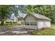 Exterior view featuring a detached two-car garage with traditional white doors and dormer window at 5308 Stableview Ct, Holly Springs, NC 27540