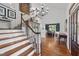 Spacious foyer with hardwood floors, a grand staircase, and views into the dining area, creating an inviting entrance at 5308 Stableview Ct, Holly Springs, NC 27540