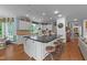 Spacious kitchen featuring a large island with seating, modern appliances, and an open layout at 5308 Stableview Ct, Holly Springs, NC 27540