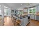 Spacious kitchen with a large island, seating, modern appliances, and a seamless transition to the outdoor living area at 5308 Stableview Ct, Holly Springs, NC 27540