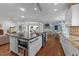 Open concept kitchen with a center island, stainless steel appliances, and hardwood floors at 5308 Stableview Ct, Holly Springs, NC 27540