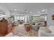 Bright and airy living room open to the kitchen, featuring hardwood floors and large windows at 5308 Stableview Ct, Holly Springs, NC 27540